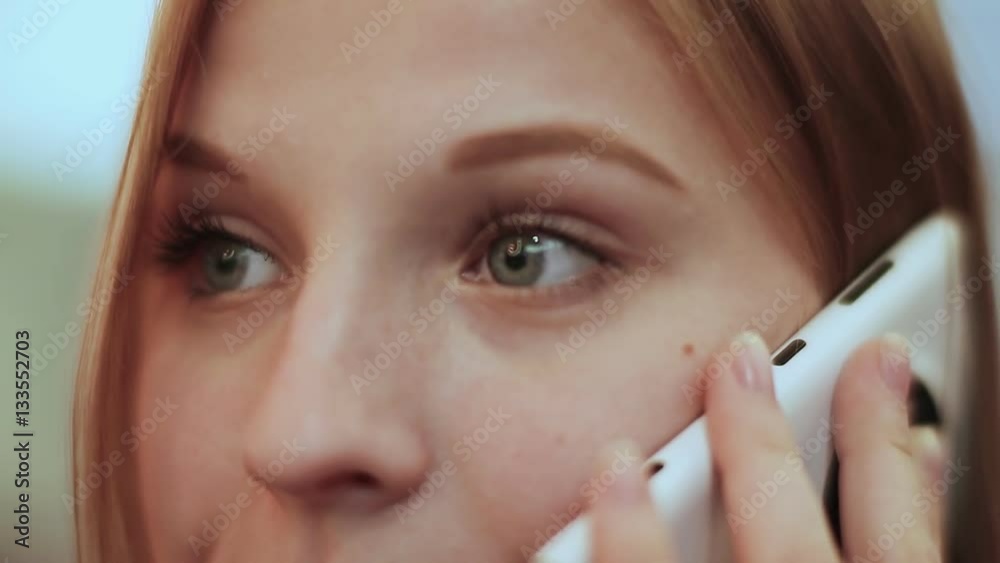 Beautiful young girl talking on mobile phone. Face close-up. Beautiful young girl talking on mobile phone. Face close-up.