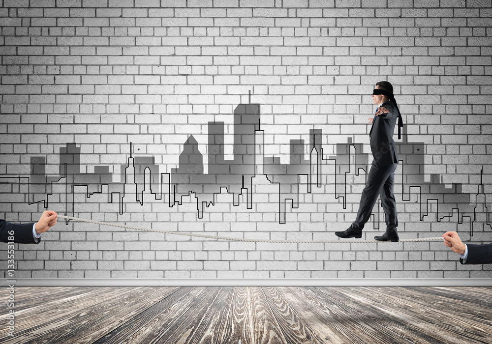 Business concept of risk support and assistance with man balancing on rope Business concept of risk support and assistance with man balancing on rope