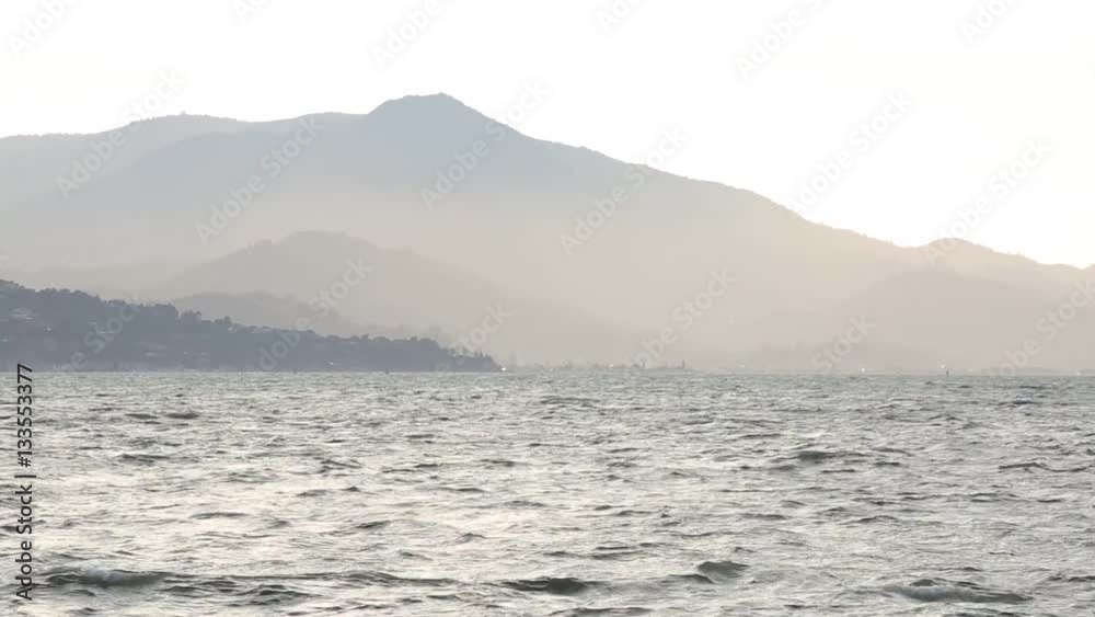Strong wind blows across the surface of the San Francisco bay at sunset looking towards Mount Tamalpais Strong wind blows across the surface of the San Francisco bay at sunset looking towards Mount Tamalpais