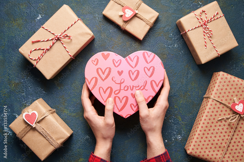 hands holds in hands heart shape gift box. love and valentines day