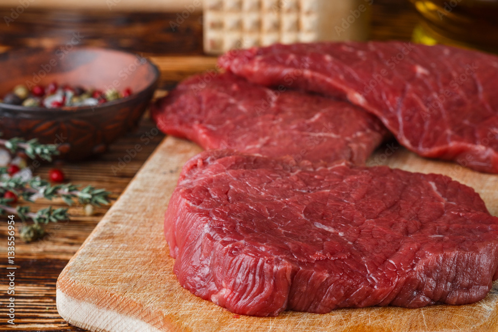 Fresh meat. Raw beef chops on a cutting Board ready to prepare a delicious dinner. Selective focus

