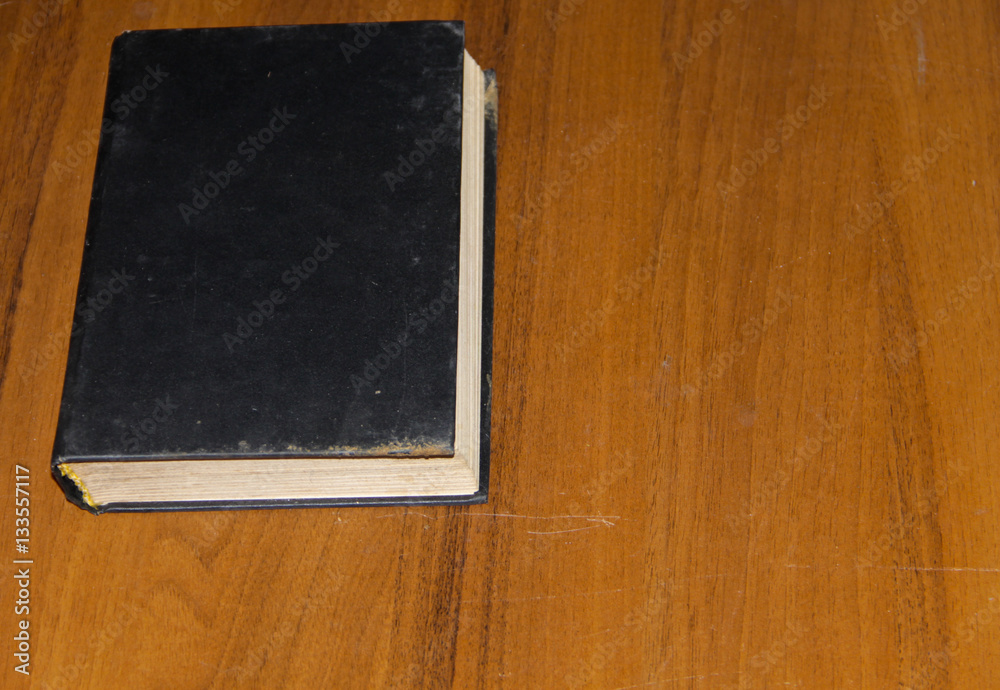 Old book on wooden table Old book on wooden table