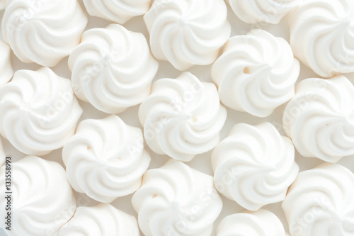 Closeup of mini meringues on white as food background. photo