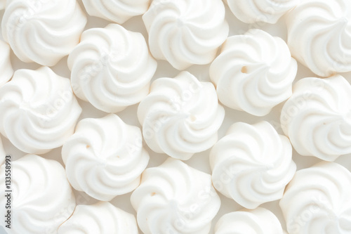 Closeup of mini meringues on white as food background.