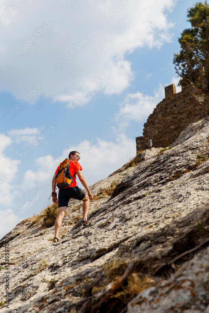 Boy with backpack on mountain