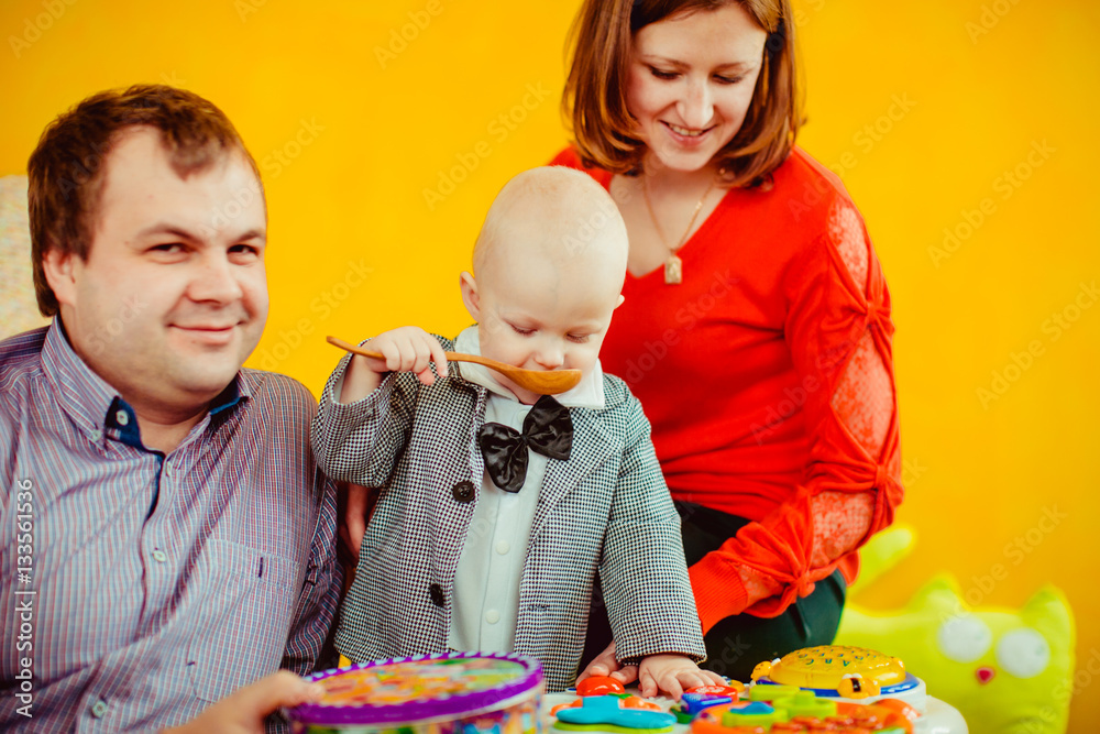 Obraz premium The mother,father and son playing with toys