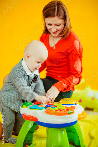 The mother and  small boy playing with  toys