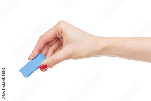 Female hand holds the eraser.