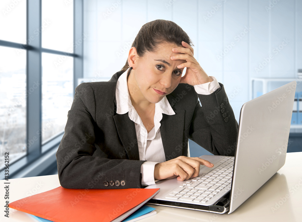 businesswoman wearing business suit working on laptop computer at modern office room