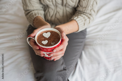 Woman hands holding a Cup of hot cocoa or  chocolate for  background, traditional drink  the winter time, lifestyle photos, top view, Valentine's day