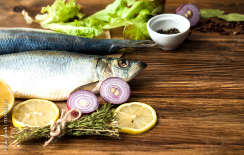 fresh fish with vegetables and spices, cooking seafood. On a wooden background. For restaurants