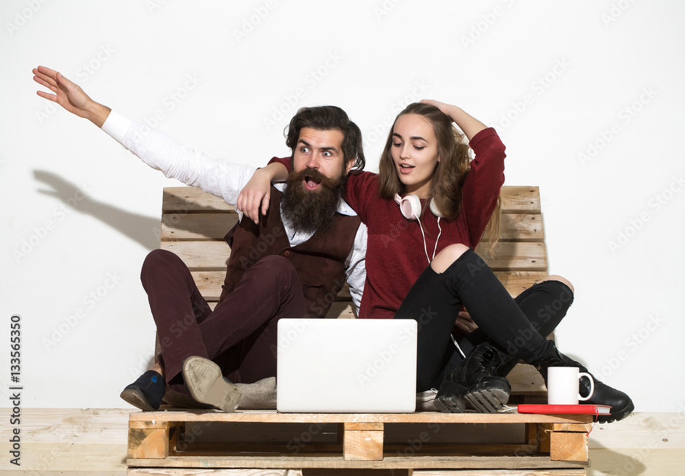 Shocked young couple use laptop
