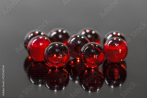 red balls on black glass surface