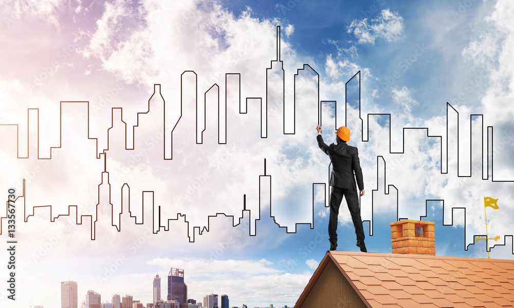 Man architect draw silhouette of modern city on blue sky. Mixed media Man architect draw silhouette of modern city on blue sky. Mixed media