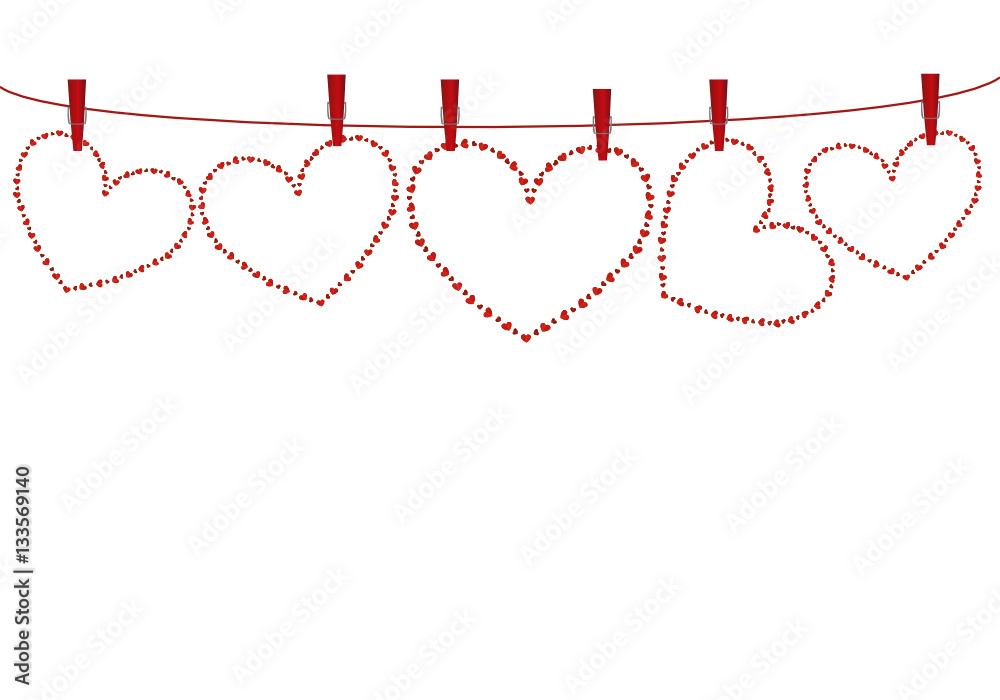 Red hearts  hanging on a rope with slothespins. Valentine's Day.