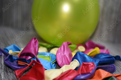 Colored balloons on a wooden table.