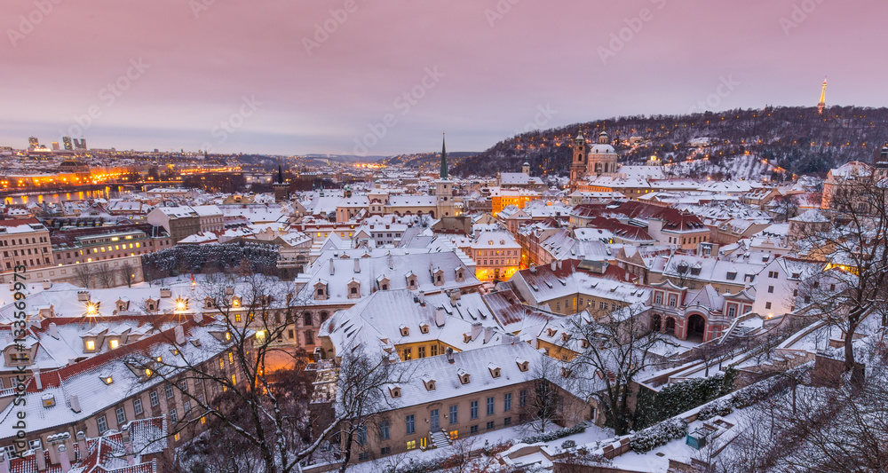 Prague in winter time, view on snowy roofs.