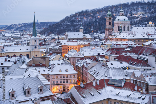 Prague in winter time, view on snowy roofs.