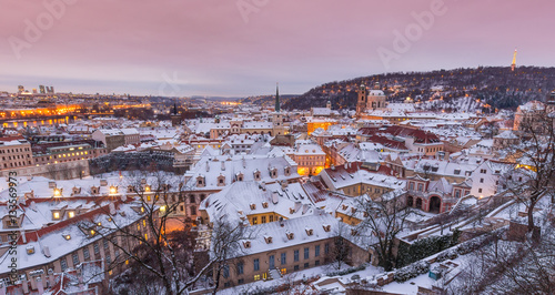 Prague in winter time, view on snowy roofs.