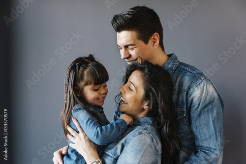 Happy young family with their daughter.