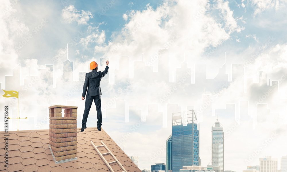 Man architect draw silhouette of modern city on blue sky. Mixed Man architect draw silhouette of modern city on blue sky. Mixed