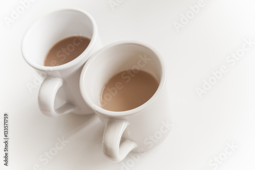 Two big cups full of coffee with milk