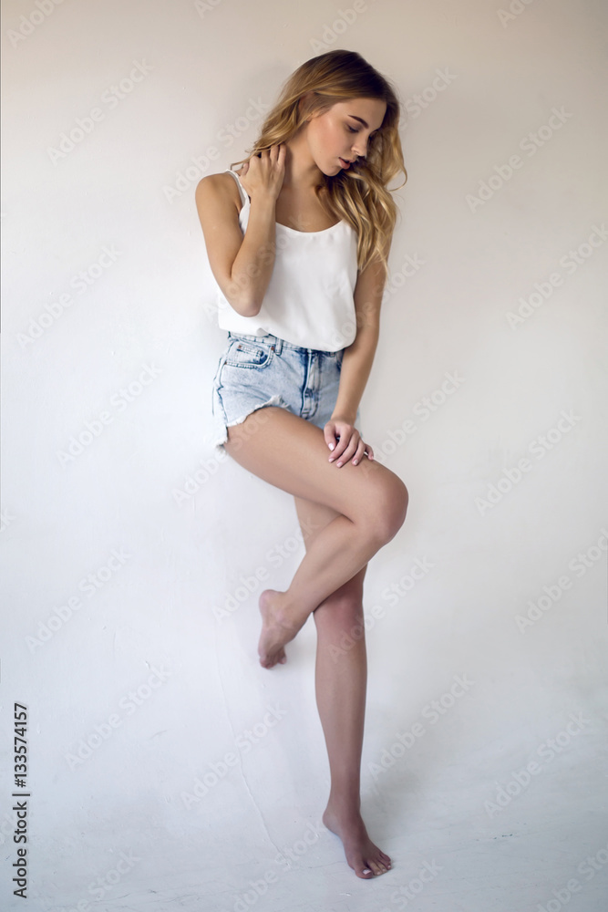 Bathtub Recently Pedestrian young sexy blonde girl in short denim shorts and a white t-shirt on white  background Stock Photo | Adobe Stock