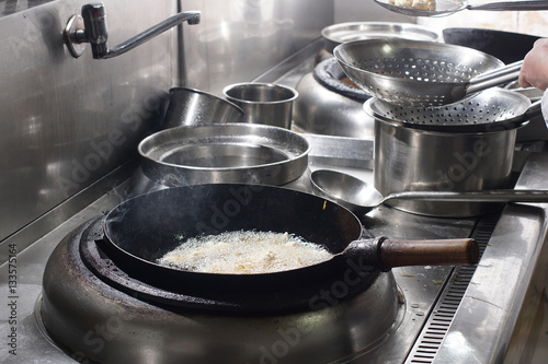 Close up of working chef preparing chinese food