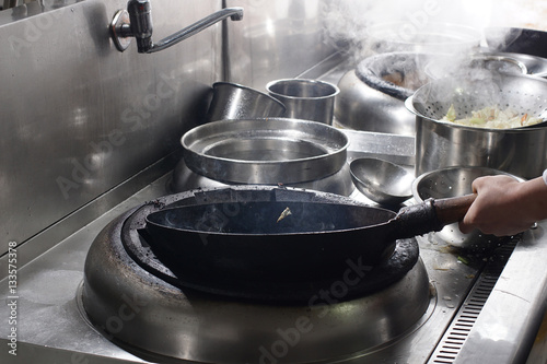 Close up of working chef preparing chinese food