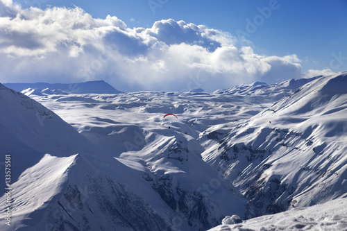 Speed flying in sun winter mountains