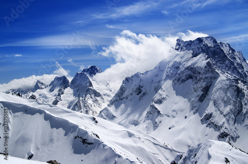 Winter mountains with snow cornice and blue sky with clouds in n © BSANI
