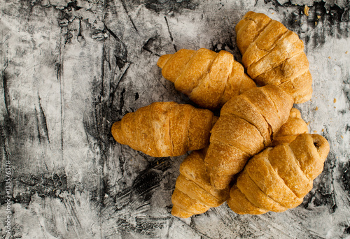 Fresh croissant on scratched background