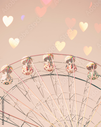 Vintage ferris wheel with heart shaped overlay photo