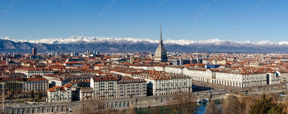 Winter panorama of Turin (Piedmont, Italy), with the Mole Antonelliana, Vittorio Veneto square and snowy mountains on the background