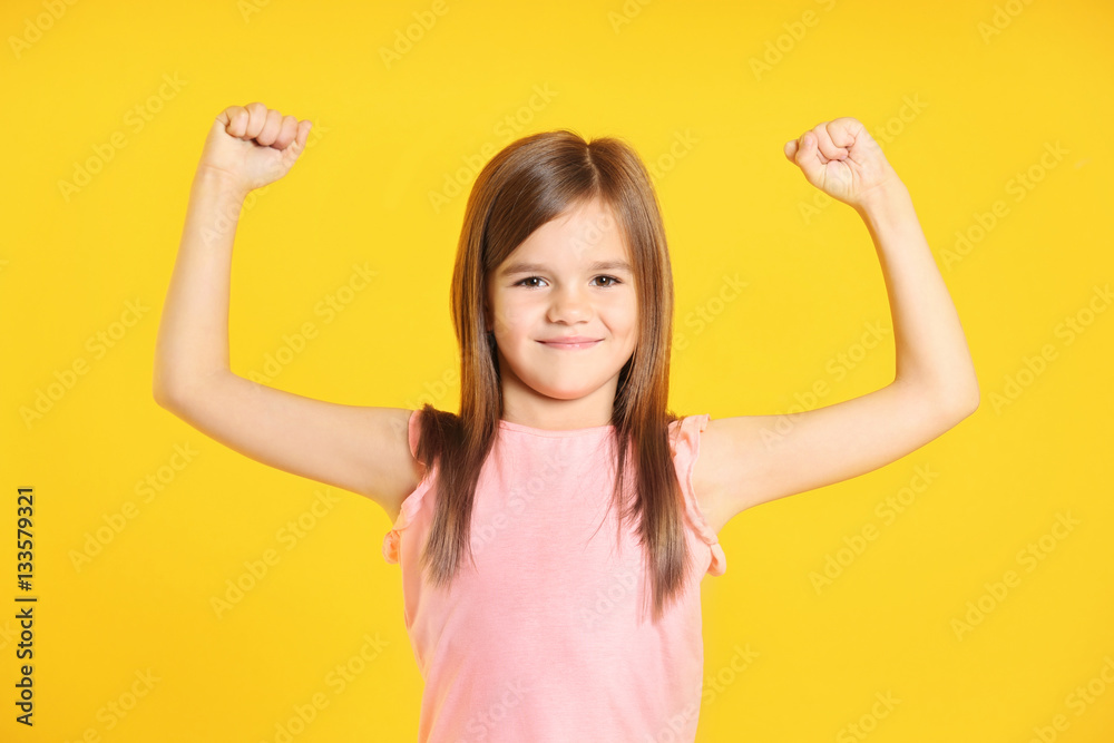 Attractive little girl on yellow background Attractive little girl on yellow background