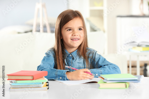 Little girl writing somethi...