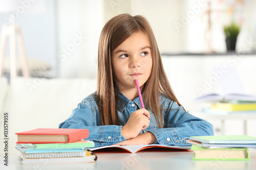Little girl writing somethi...