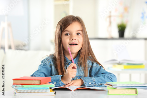 Little girl writing somethi...