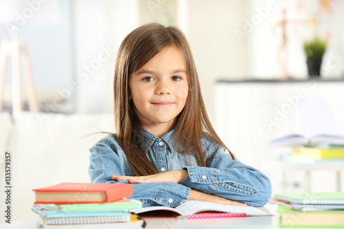 Little girl with books sitt...