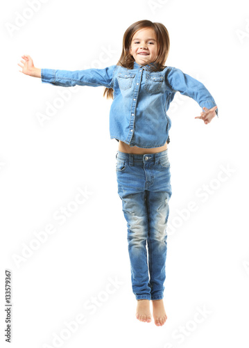 Cheerful little girl jumpin...