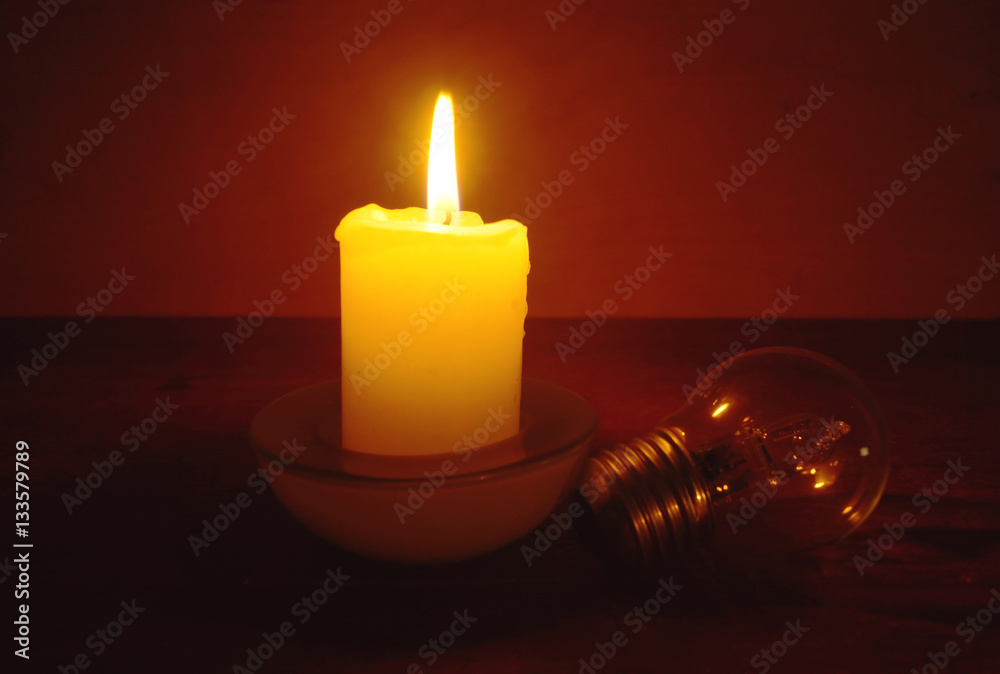 Burning candle and lamp. Power outage. Missing electricity - blackout begin.