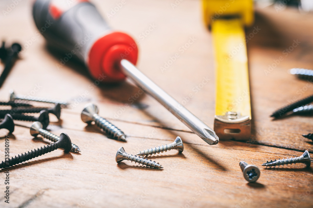 Fotografie Screwdriver and nails on wooden background
