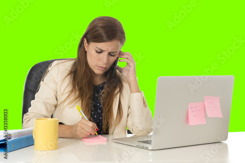  businesswoman in at office computer desk talking on mobile phone on green chroma key screen photo