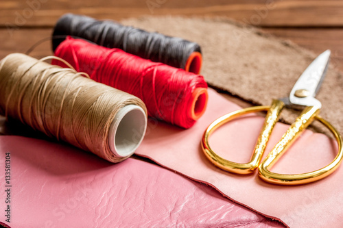 leather craft instruments on wooden background close up