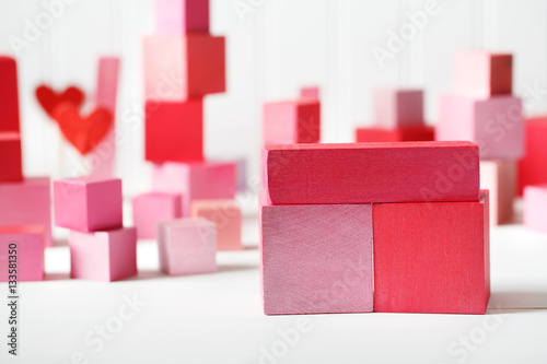 Red and pink wooden blocks with small hearts
