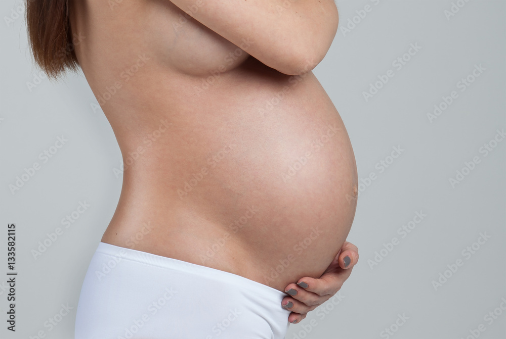 Belly of a pregnant woman isolated on white background