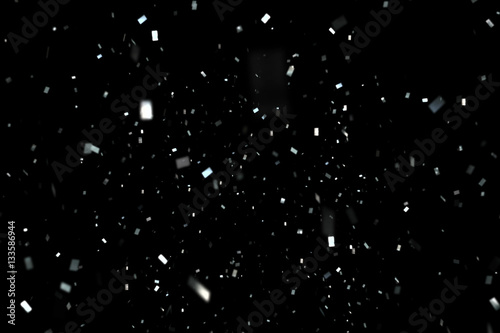 falling silver metallic glitter foil confetti, animation movement on black background, holiday and festive fun