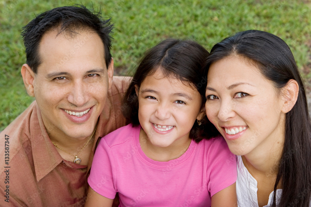 Loving Asain parents and their daughters smiling. Loving Asain parents and their daughters smiling.