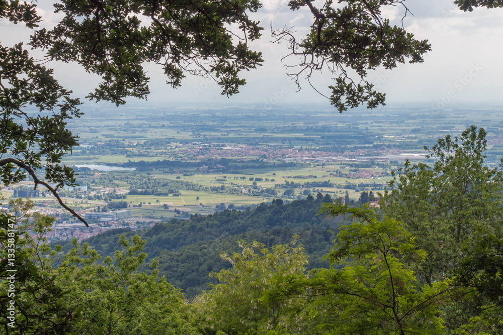 View of valley through green trees. Remembrance park. Piedmont Italy. View of valley through green trees. Remembrance park. Piedmont Italy.