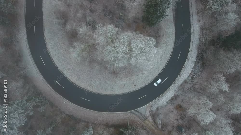 Road curve in the forest - aerial view, hoar frost